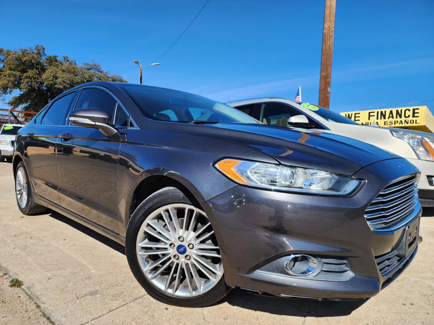 2015 GRAY /BEIGE Ford Fusion SE (3FA6P0HD4FR) with an 1.5L L4 DOHC 16V engine, AUTO transmission, located at 2660 S.Garland Avenue	, Garland, TX, 75041, (469) 298-3118, 32.885387, -96.656776 - CASH$$$$$$ FUSION! This is a Super Clean 2015 FORD FUSION SE! BACK UP CAMERA! BLUETOOTH! SYNC! XM SAT RADIO! SUPER CLEAN! MUST SEE! Come in for a test drive today. We are open from 10am-7pm Monday-Saturday. Call us with any questions at 469-202-7468, or email us DallasAutos4Less@gmail.com. - Photo#0